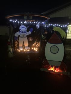 a car decorated with lights and an image of a spaceman on the back door