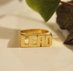 Modern Block letter name ring in 14k solid gold is a perfect statement ring for you or gift for your loved one, Best friend and so many other gift possibilities. Yes Modern block letter ring is Unisex. Sample of words: SEPARATE HANDS OR ONE FINGER 1.LOVE YOU. 2.PEACE LOVE 3.MEN NAME 3.YOUR NAME and many more....( contact me for more info) *COLOR* White gold 14k. Yellow gold 14k. Pink gold 14k. *SIZES* NAME 3/4'' to 1 '' depends on the name it is going to be adjusted accordingly by the ring size. Gold Rings With Custom Text For Anniversary, Custom Text Gold Rings For Anniversary, Gold Promise Ring With Custom Text, Gold Ring With Custom Text, Custom Text Gold Ring, Gold Initial Ring With Custom Name For Promise, Name Rings Personalized, One Best Friend, Gold Initial Ring