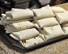 several burritos are stacked on a plate with a red sticker over it