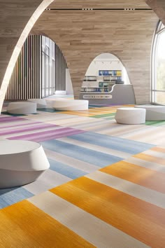 an empty room with colorful carpeting and bookshelves on the wall behind it