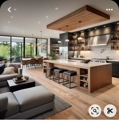 an open concept kitchen and living room with wood flooring is featured in this image