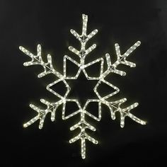 a lighted snowflake on a black background with white lights in the shape of a star