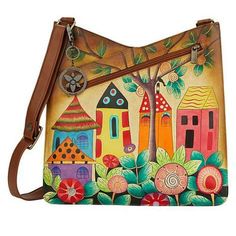 a hand painted purse with houses and trees