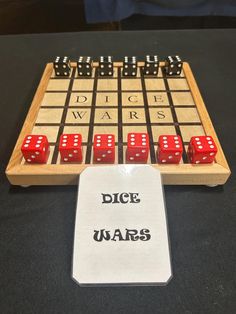 the dice wars board game is set up on a table with two red dices