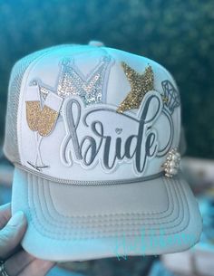 Gray/White Trucker with patches: Bride, diamond engagement ring, gold star, Bride, champagne toast, silver sequin crown, rhinestone & pearl brooch. Adjustable with snap back closure. Great for bridal gifts, wedding gifts, and much more. *Star size and brooch will slightly vary* Diamond Engagement Ring Gold, Engagement Ring Gold, Champagne Toast, Bridal Gift, Pearl Brooch, Gold Star, Gifts Wedding, Silver Sequin, Bridal Gifts