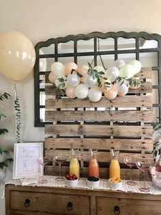 a buffet table with balloons and drinks on it