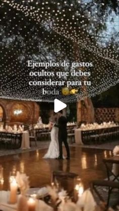 a man and woman are standing in the middle of a dance floor with candles on it