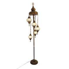 an old fashioned floor lamp with five lights on the top and one light on the bottom