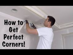 a man is painting the ceiling with white paint