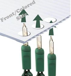 three green plugs connected to each other with arrows pointing up and down on them