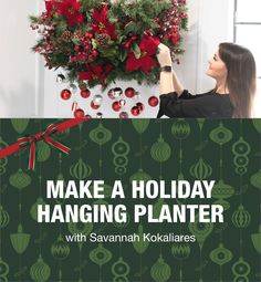 a woman is holding up a holiday hanging planter