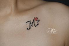 a man's chest with a heart and m tattoo on his left side shoulder