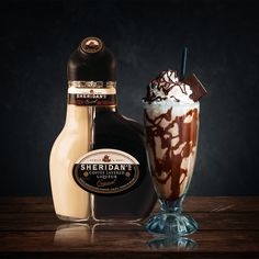 an ice cream sundae next to a bottle of sheildan's chocolate milkshake