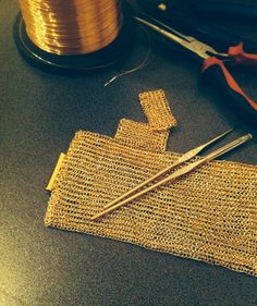 a pair of scissors and some thread on a table