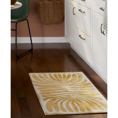 a white and gold rug in a kitchen