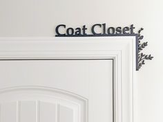 there is a coat closet sign above the door