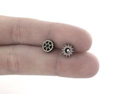 Tiny Gear Earring Studs feature your choice of a pair of miniature gear charms, cog charms or a unique mismatch set. The gear earrings are part of my Steampunk jewelry collection created by combining an assortment of unique charms with tiny metal gears. The steampunk stud earrings are stunning on their own, or paired with the other matching steampunk jewelry and accessory designs available separately throughout the shop. GEAR SIZE: Approx 1/4inch (6mm) MATERIAL: Nickel Free Alloy Metal Gears, Ni Steampunk Clothing Women, Mens Piercings, Steampunk Outfits Women, Women Steampunk, Gear Earrings, Men's Piercings, Studs For Men, Metal Gears, Stud Earrings For Men