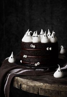 a chocolate cake with white frosting and spooky eyes