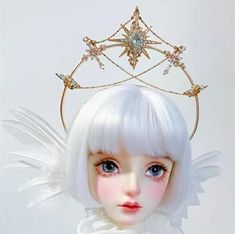 a doll with white hair wearing a tiara