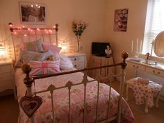 a bed room with a neatly made bed next to a dresser and a mirror on the wall