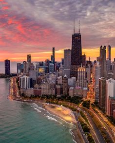 an aerial view of the chicago skyline at sunset