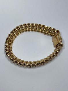 Very beautiful gold metal bracelet with curb chain link, the ratchet blade clasp with a safety figure of eight. Dimensions: 19x1.1cm Very pretty piece - excellent condition, clasp in working condition and just a little scratched. Heart stroke! Gold Cuban Link Bracelet With Chain, Classic Link Chain Bracelet With Gold Clasp, Classic Metal Chain Bracelet With Gold Clasp, Classic Chain Link Gold Bracelet, Cuban Link Gold Bracelet, Classic Cuban Link Gold Bracelet, Formal Gold Cuban Link Bracelet, Metal Link Bracelets With Gold Clasp, Gold Metal Bracelet With Clasp