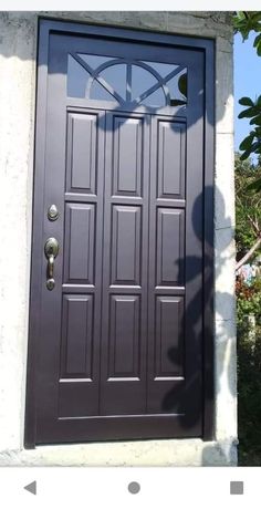 the front door is painted dark brown