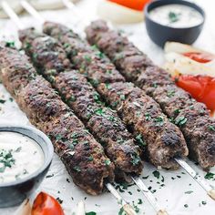 several skewers of meat and vegetables on a table