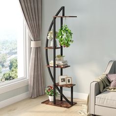 a living room with a couch, chair and book shelf in front of a window