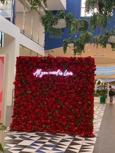 a large red flower wall with the words mr and mrs written in white on it