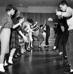 a group of people dancing on a wooden floor