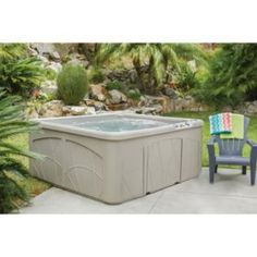 an outdoor hot tub with steps and chair