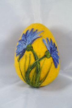 a yellow ball with blue flowers painted on it