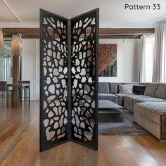 an open room divider in the middle of a living room with wood flooring