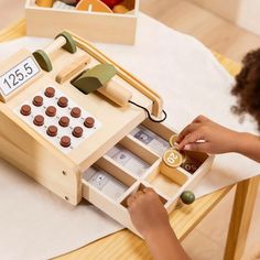 a child playing with a wooden counting machine