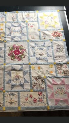 a quilted table topper with many different designs on it