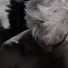 the back of an older man's head with white hair and no shirt on