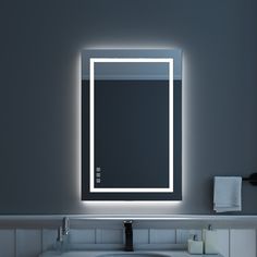 a bathroom sink with a lighted mirror above it