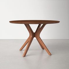 a round wooden table with two crossed legs