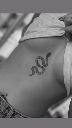 a woman with a snake tattoo on her back