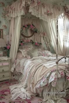 a canopy bed with pink flowers on it