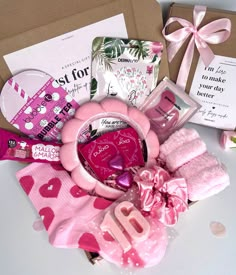 a gift box filled with lots of pink items