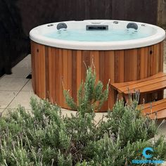 a hot tub sitting next to a wooden bench