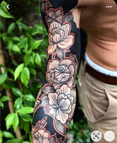 an arm tattoo with flowers on it