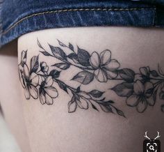 a woman's thigh with flowers on it