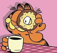 a cartoon character holding a coffee cup and sitting at a table with a donut on it's face