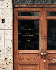 an old wooden door with the words daughter son written on it's glass window