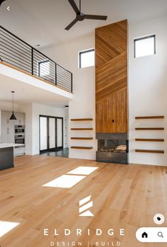 an empty living room with wooden floors and ceiling fans in the middle of the room