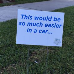 a sign in the grass that says, this would be so much easier in a car