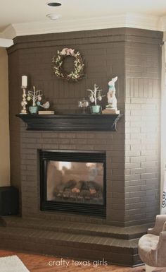 a living room filled with furniture and a fire place in front of a brick fireplace